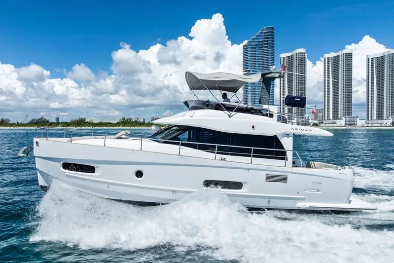 Roma Yacht Photos Pics Azimut Magellano 43 yacht cruising near city skyline, 2021 model.