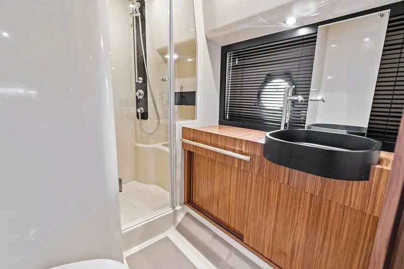 Roma Yacht Photos Pics Luxurious bathroom in 2021 Azimut Magellano 43 yacht with modern fixtures and wood accents.