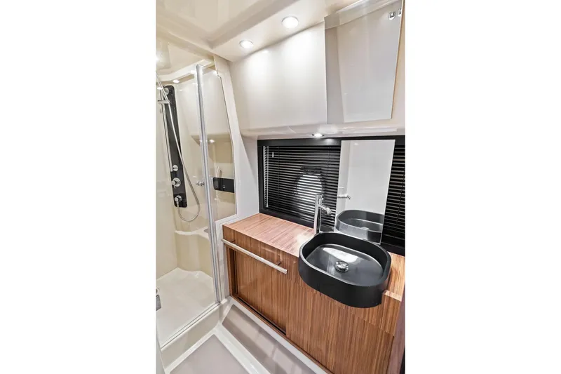 Roma Yacht Photos Pics Luxurious bathroom in 2021 Azimut Magellano 43 yacht with modern fixtures and wood accents.