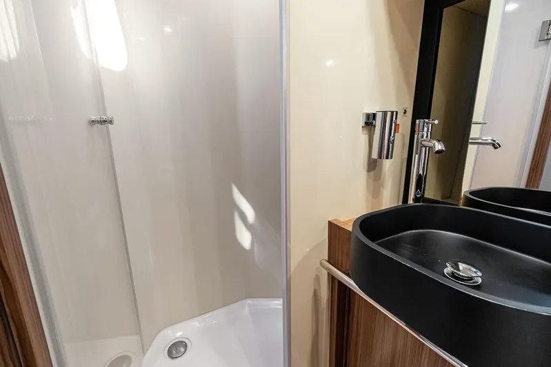Roma Yacht Photos Pics Modern bathroom interior of 2021 Azimut Magellano 43 yacht, featuring sleek sink and shower.