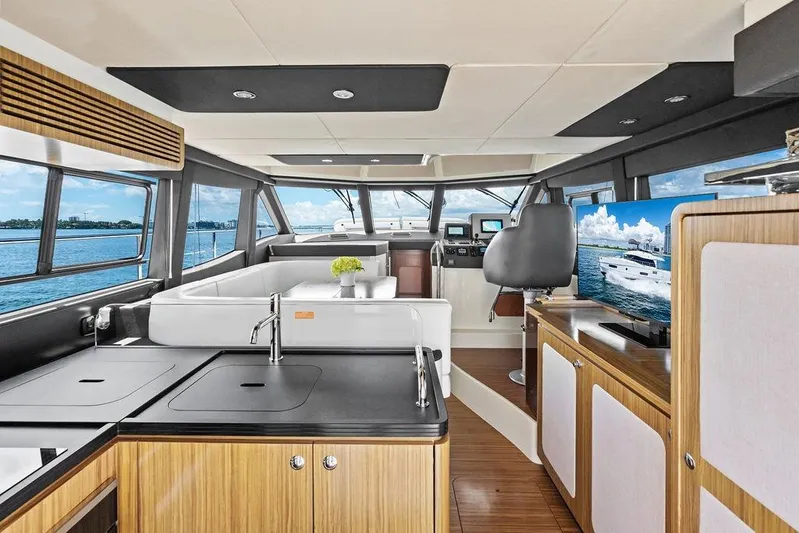 Roma Yacht Photos Pics Luxurious interior of 2021 Azimut Magellano 43 yacht with modern kitchen and panoramic windows.