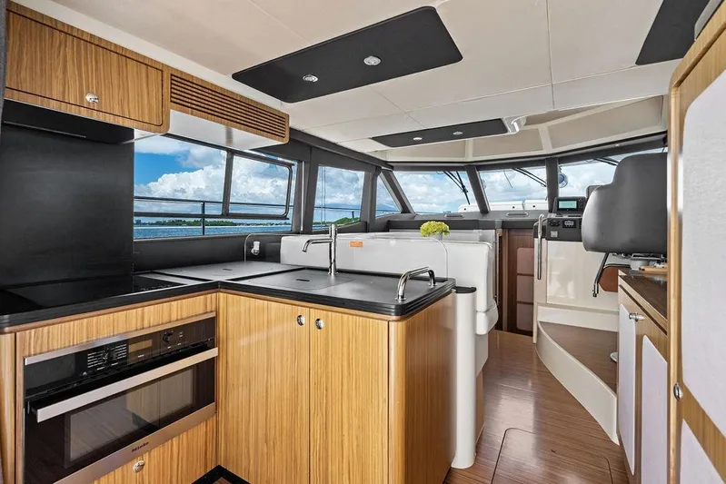 Roma Yacht Photos Pics Luxurious interior of 2021 Azimut Magellano 43 yacht with modern kitchen and panoramic windows.