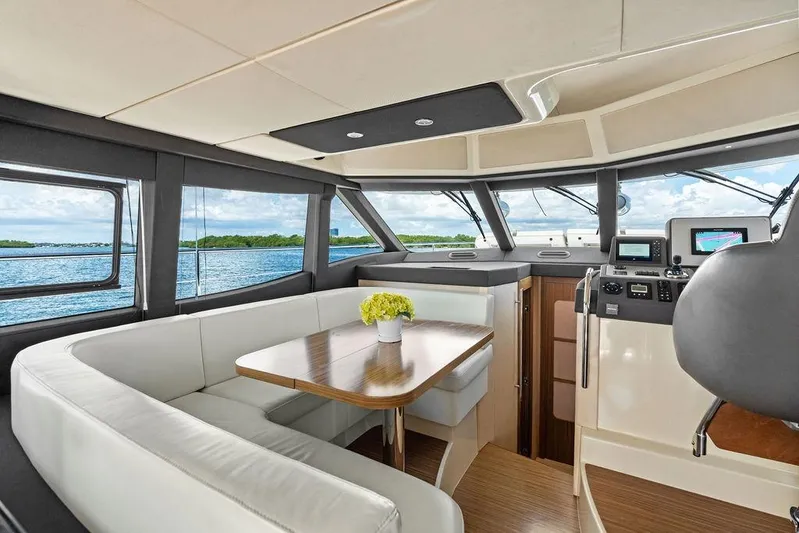 Roma Yacht Photos Pics Luxurious interior of 2021 Azimut Magellano 43 yacht with panoramic windows and elegant seating.