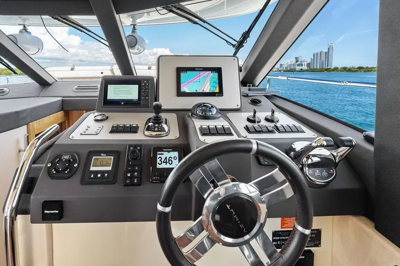 Roma Yacht Photos Pics Cockpit of 2021 Azimut Magellano 43 yacht with navigation controls and ocean view.