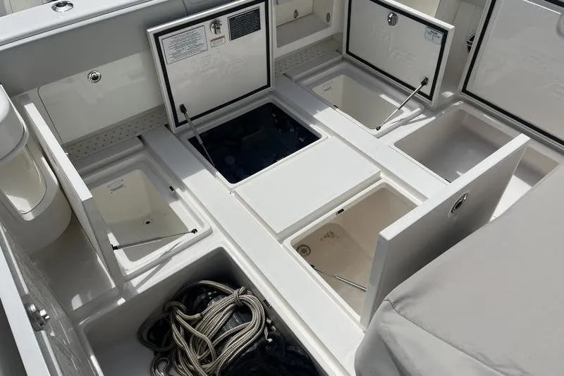  Yacht Photos Pics 2022 SeaVee 370z boat storage compartments with open hatches and coiled ropes.