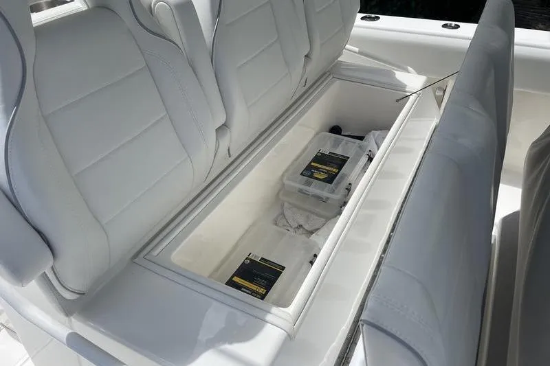  Yacht Photos Pics 2022 SeaVee 370z boat storage compartment with white cushioned seats and organized storage boxes.