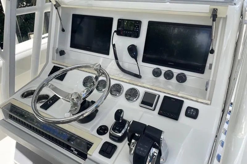  Yacht Photos Pics Control panel of 2022 SeaVee 370z boat with steering wheel and electronic displays.