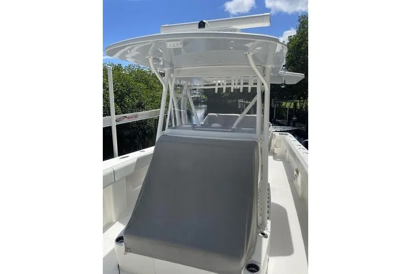  Yacht Photos Pics 2022 SeaVee 370z boat with T-top and console, docked near lush greenery.