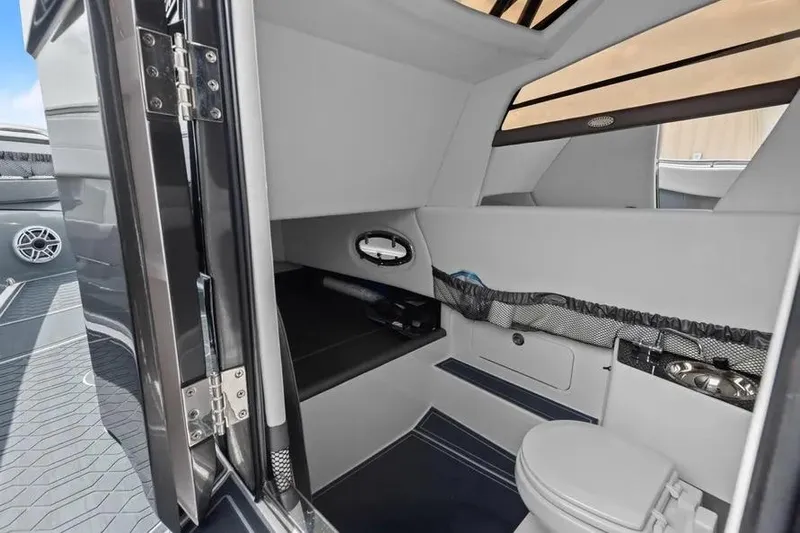  Yacht Photos Pics 2023 Nor-Tech 390 Sport Center Console cabin interior with seating and toilet.