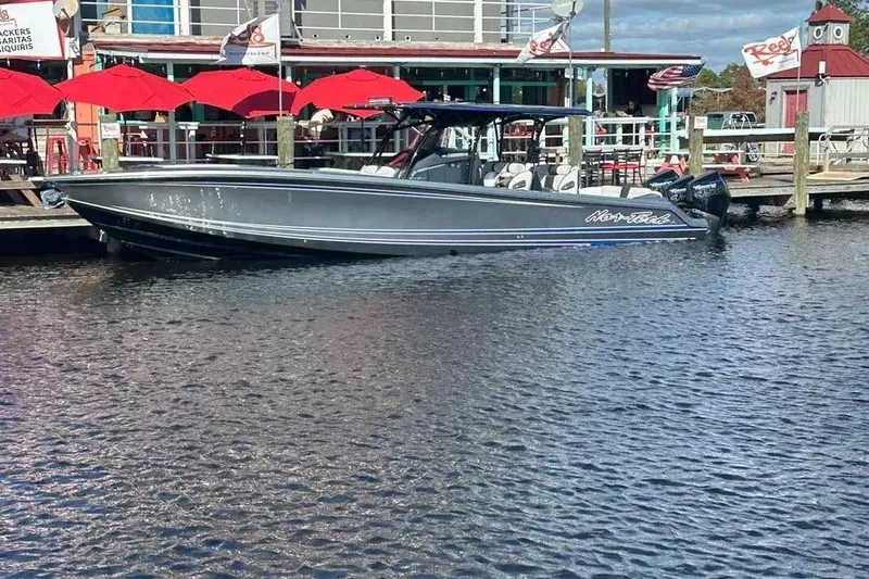  Yacht Photos Pics 2023 Nor-Tech 390 Sport Center Console boat docked by waterfront restaurant.