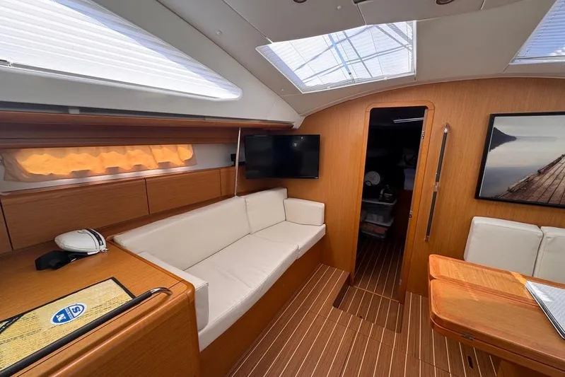  Yacht Photos Pics Interior of 2011 Jeanneau 50 Deck Saloon with modern furnishings and natural light.