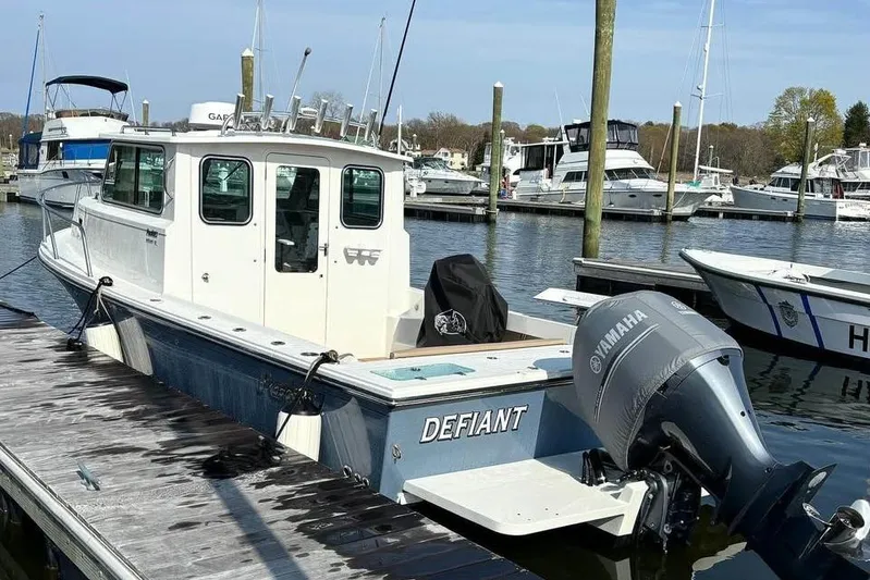  Yacht Photos Pics 2019 Parker 2520 XL Sport Cabin boat docked with Yamaha outboard engine.