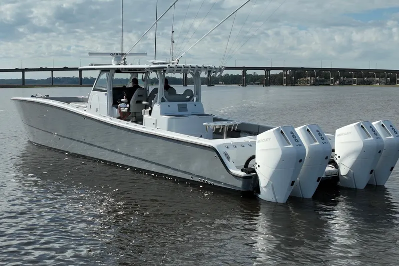  Yacht Photos Pics 2022 Freeman 47 boat with four Mercury engines on calm water.
