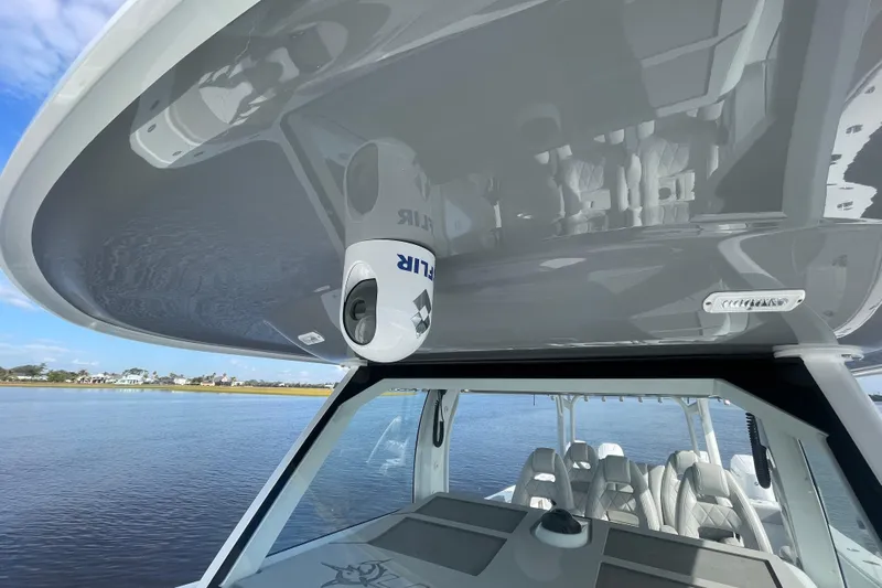  Yacht Photos Pics 2022 Freeman 47 boat with FLIR camera, sleek design, and luxurious seating on calm water.