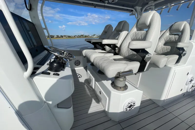  Yacht Photos Pics Luxurious interior of 2022 Freeman 47 boat with plush seating and modern steering console.