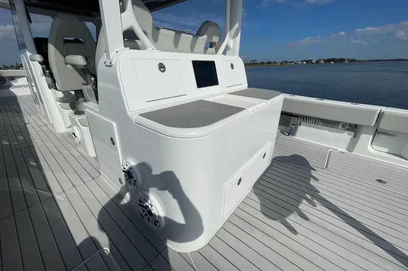  Yacht Photos Pics 2022 Freeman 47 boat interior with seating and control panel, docked by calm waters.