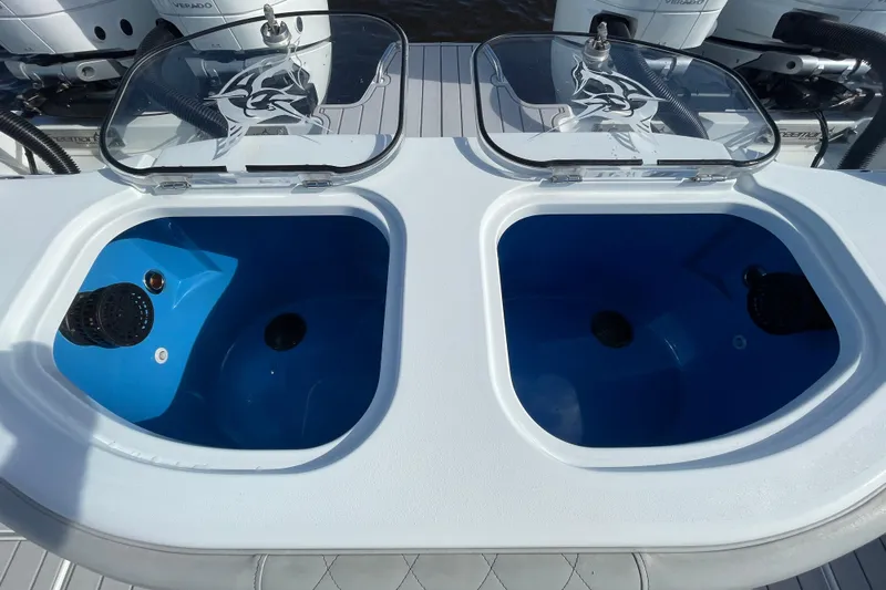  Yacht Photos Pics Livewell compartments on a 2022 Freeman 47 boat, featuring clear lids and blue interiors.