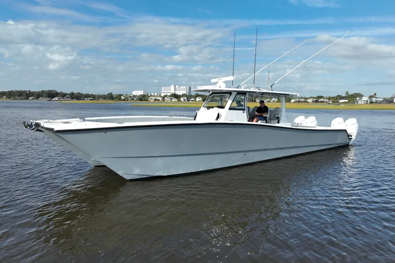  Yacht Photos Pics 2022 Freeman 47 boat on calm water under a partly cloudy sky.