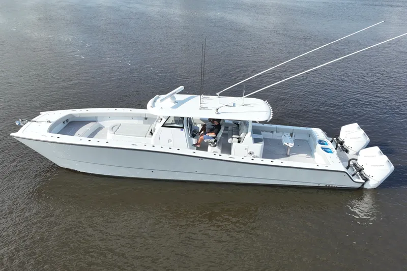  Yacht Photos Pics 2022 Freeman 47 boat on calm water, featuring dual outboard motors.