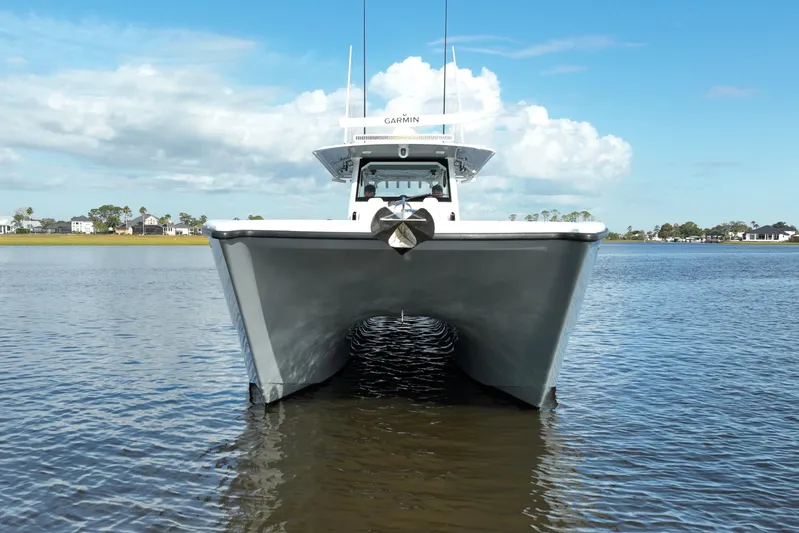  Yacht Photos Pics Front view of 2022 Freeman 47 catamaran on calm water under blue sky.