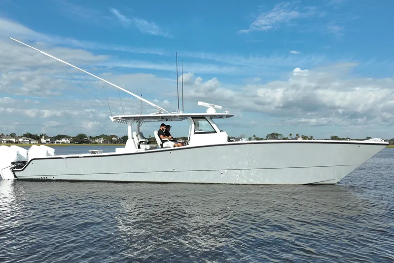  Yacht Photos Pics 2022 Freeman 47 boat on calm water under a blue sky.