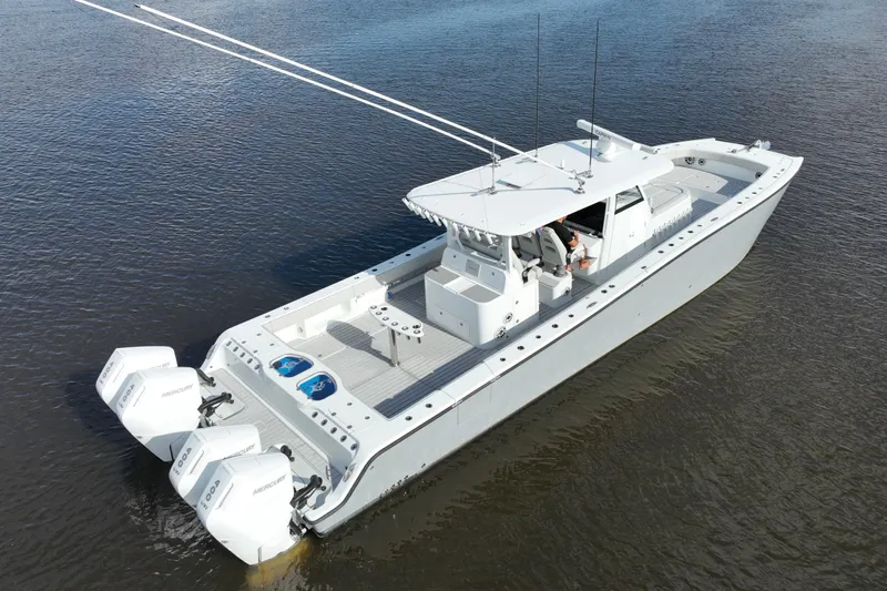  Yacht Photos Pics 2022 Freeman 47 boat with triple Mercury engines on calm water.