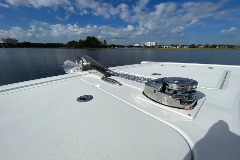  Yacht Photos Pics Bow of 2022 Freeman 47 boat with anchor and winch, calm water background.