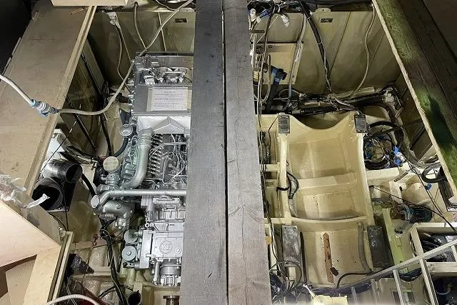  Yacht Photos Pics Engine compartment of a 1990 Riva Corsaro 20 boat, showcasing detailed mechanical components.