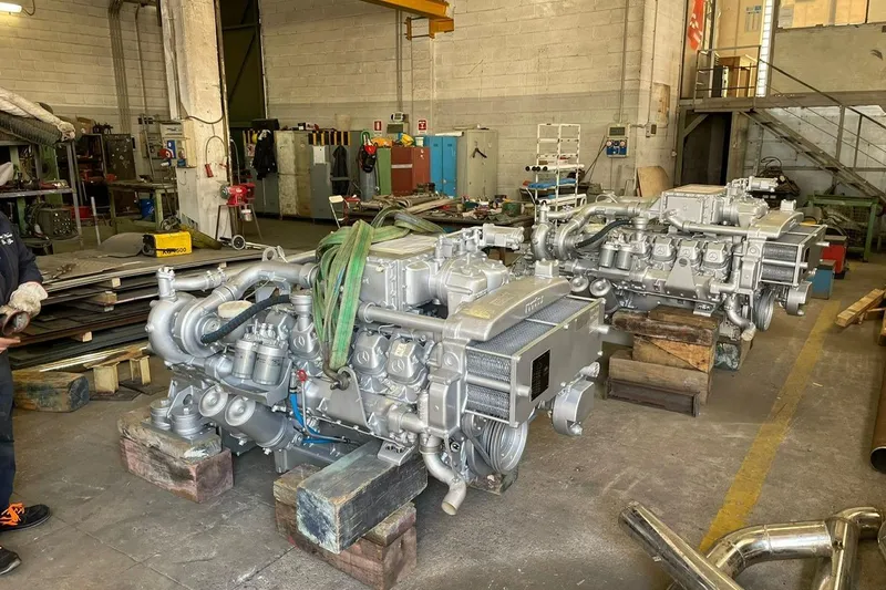  Yacht Photos Pics Riva Corsaro 20 engines in a workshop, 1990 model, industrial setting.