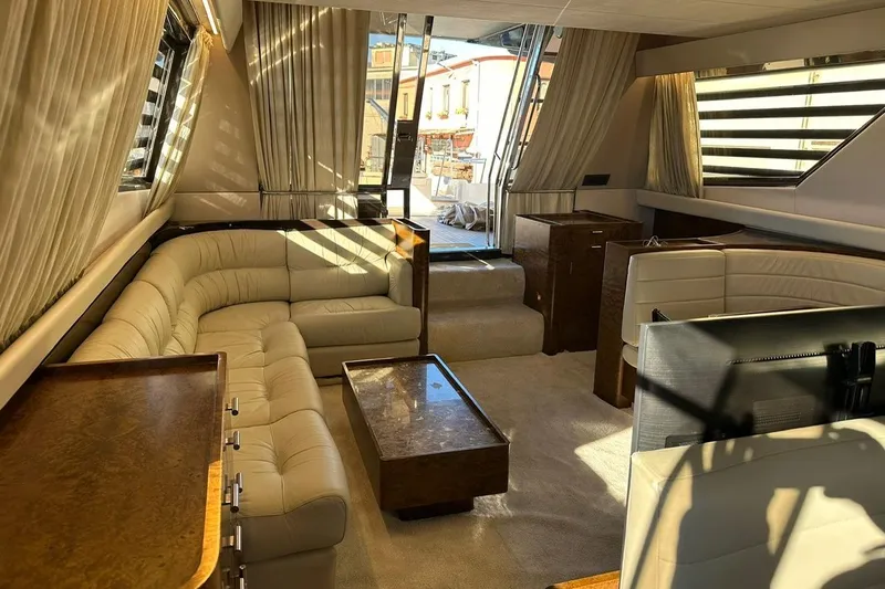 Yacht Photos Pics Luxurious interior of a 1990 Riva Corsaro 20 yacht with elegant seating and wooden accents.