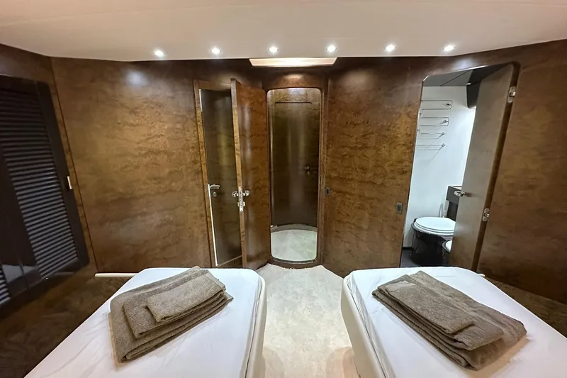  Yacht Photos Pics Luxurious interior of 1990 Riva Corsaro 20 yacht with twin beds and elegant wood paneling.