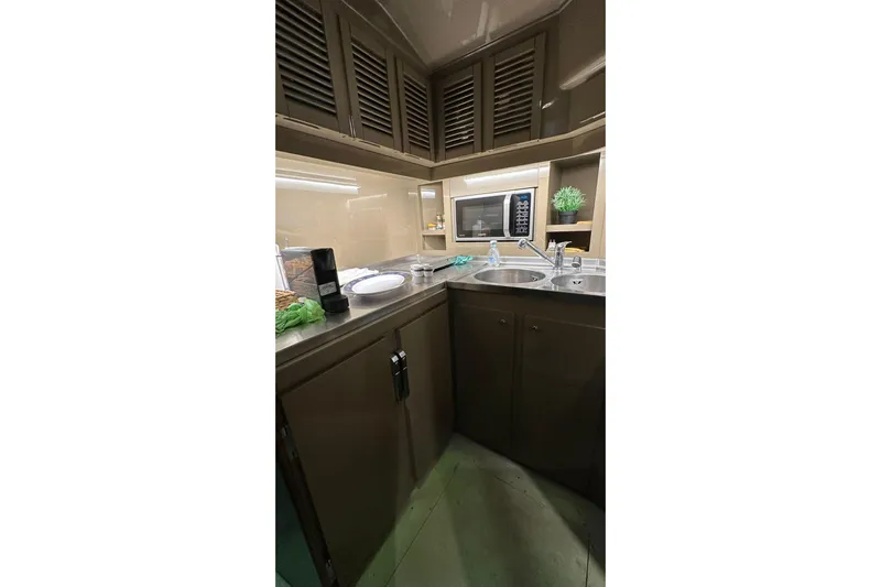  Yacht Photos Pics Compact kitchen area in a 1990 Riva Corsaro 20 yacht with modern amenities.