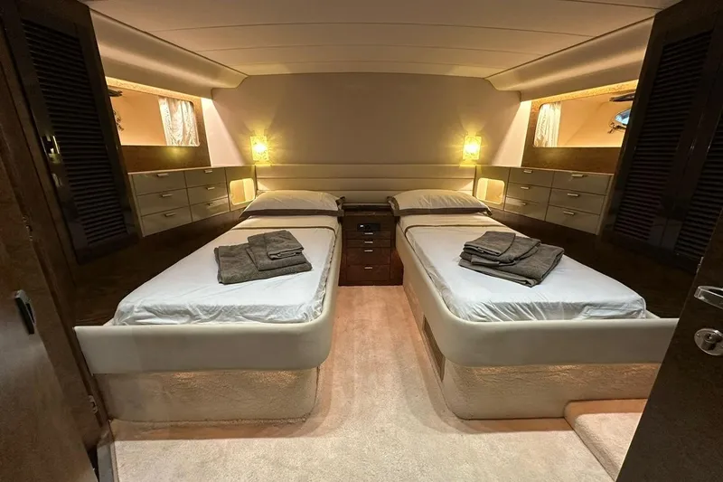  Yacht Photos Pics Luxurious 1990 Riva Corsaro 20 yacht cabin with twin beds and elegant lighting.