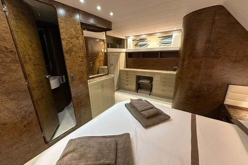  Yacht Photos Pics Luxurious interior of a 1990 Riva Corsaro 20 yacht, featuring elegant wood finishes and modern amenities.