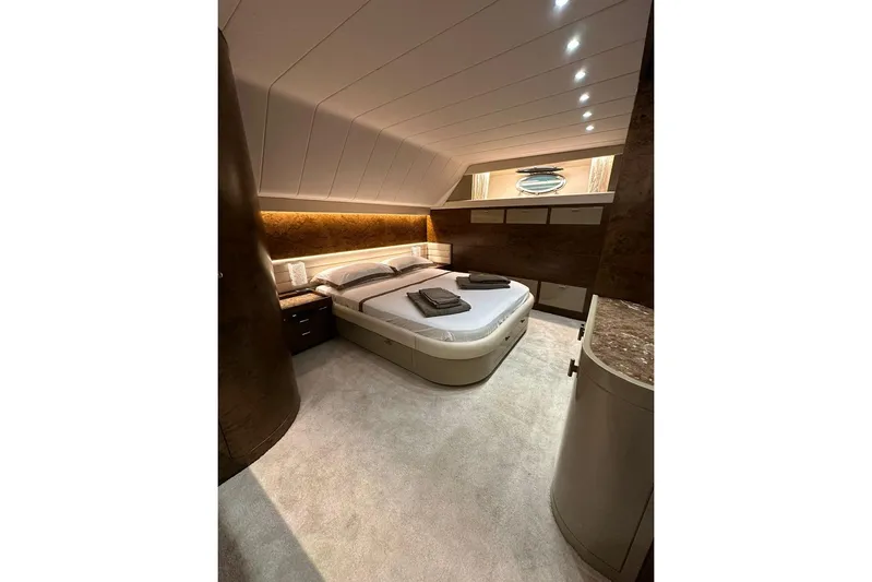  Yacht Photos Pics Luxurious bedroom interior of 1990 Riva Corsaro 20 yacht with modern lighting and elegant decor.