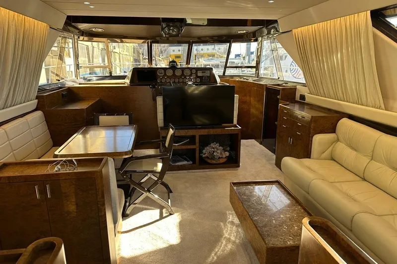  Yacht Photos Pics Luxurious interior of a 1990 Riva Corsaro 20 yacht with elegant furnishings and helm.