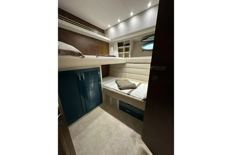  Yacht Photos Pics Interior cabin of 1990 Riva Corsaro 20 yacht with bunk beds and storage.