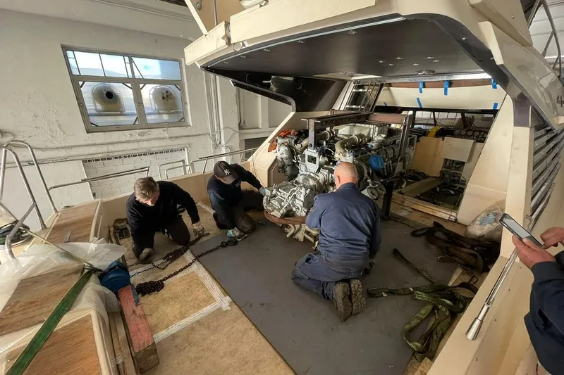  Yacht Photos Pics Technicians working on a 1990 Riva Corsaro 20 engine in a workshop.