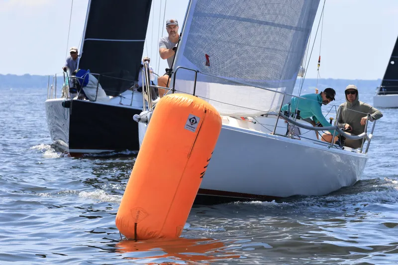  Yacht Photos Pics Sailboats racing near an orange buoy, featuring a 2005 J Boats J/100 model.