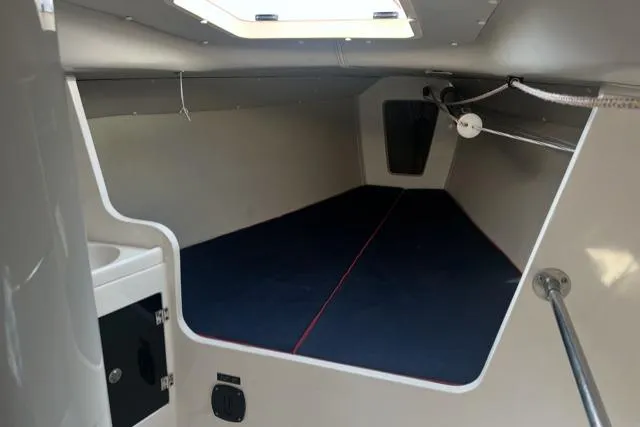  Yacht Photos Pics 2005 J Boats J/100 interior cabin with blue bedding and overhead hatch.