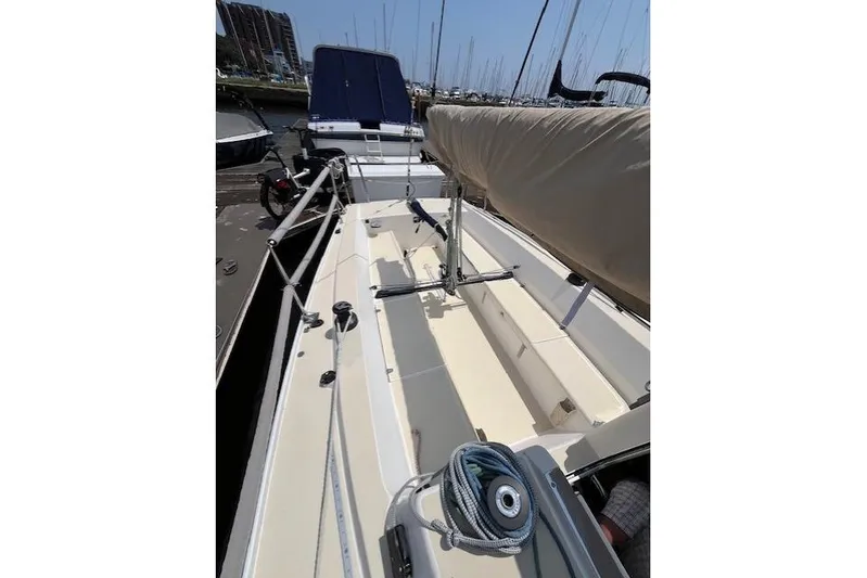 Yacht Photos Pics 2005 J Boats J/100 sailboat deck with rigging and covered boom in marina.