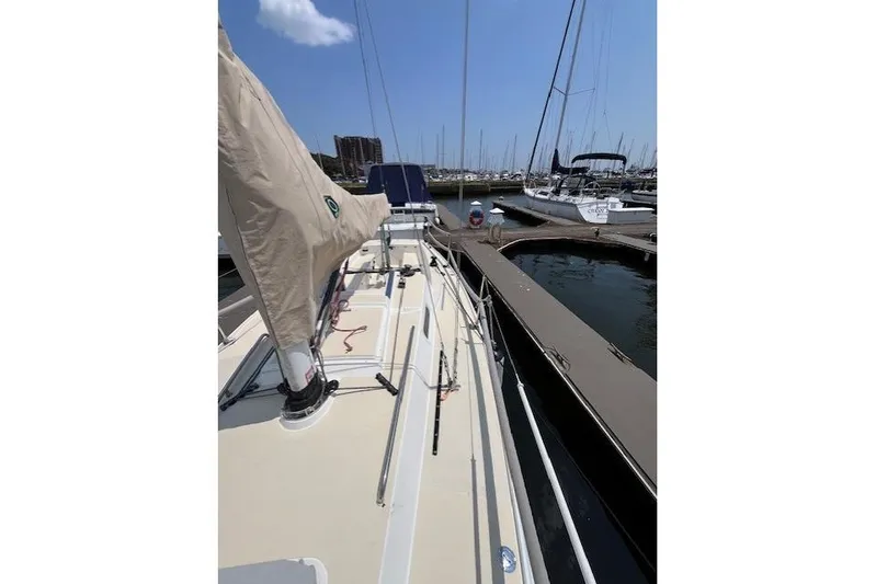  Yacht Photos Pics 2005 J Boats J/100 sailboat docked at marina under clear blue sky.