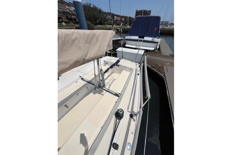  Yacht Photos Pics 2005 J Boats J/100 sailboat docked at marina, showcasing deck and rigging.