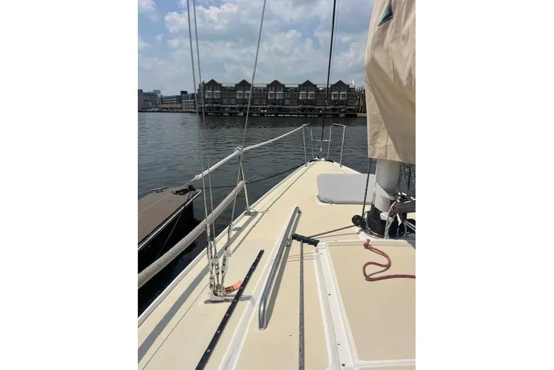  Yacht Photos Pics 2005 J Boats J/100 sailboat deck with waterfront view and cloudy sky.