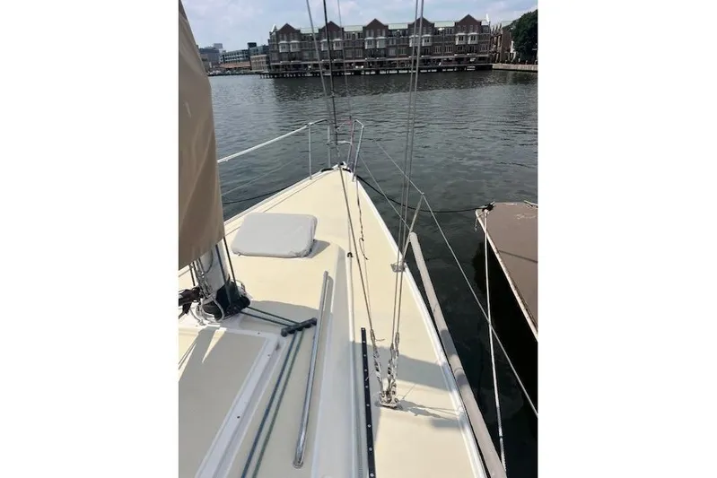  Yacht Photos Pics 2005 J Boats J/100 sailboat docked by waterfront buildings.