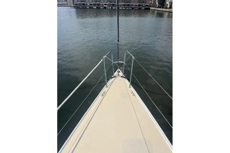  Yacht Photos Pics Bow view of 2005 J Boats J/100 sailboat on calm water.