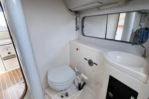  Yacht Photos Pics 2005 J Boats J/100 yacht bathroom with toilet, sink, and mirror.