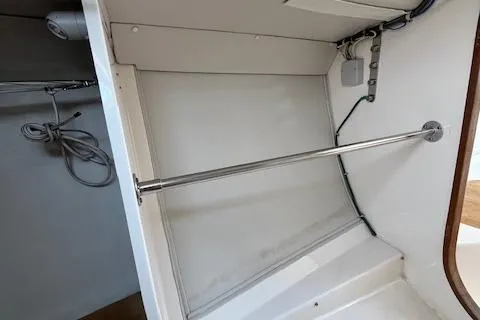  Yacht Photos Pics Interior view of 2005 J Boats J/100 sailboat, featuring a storage area with a metal rod.