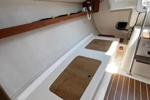  Yacht Photos Pics Interior of 2005 J Boats J/100 sailboat with wooden accents and storage compartments.