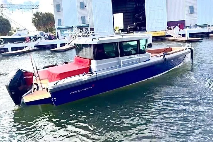  Yacht Photos Pics 2019 Axopar 28 Cabin boat docked in marina, featuring sleek design and modern amenities.